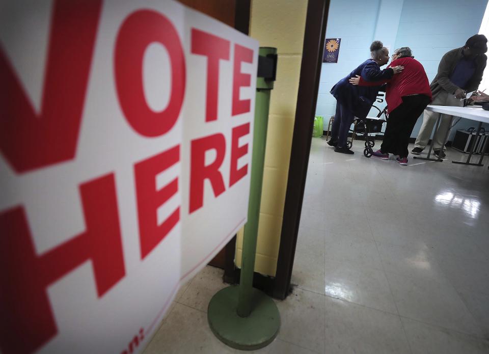 Poll worker Joyce Bradley, left, embraces Ruby Rosenthal, a former poll worker, at the Bellevue Frayser Church polling location as voters go to the polls on Tuesday, March 3, 2020, to vote in the Super Tuesday primaries. (Jim Weber/Daily Memphian via AP)