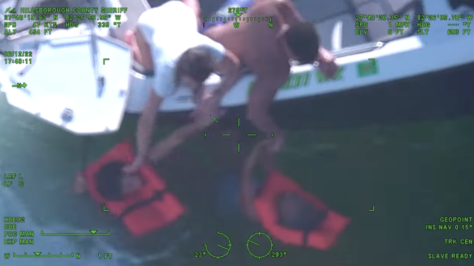 Survivors are pulled from the water by Good Samaritans after their boat capsized near Beer Can Island in Tampa Bay (Hillsborough County Sheriff’s Office)