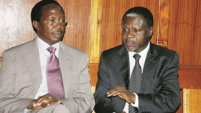 Former Kenya Power and Lighting Company Managing Director Samuel Gichuru (L) and Nambale Member of Parliament Chris Okemo (R) at a Nairobi Law Court (2016) during the hearing of the Money Laundering and corruption charges / extradition case against them