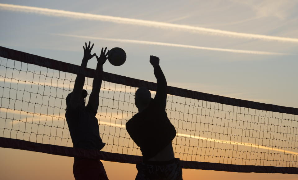 People play volleyball on Kitsilano Beach in Vancouver, British Columbia, Thursday, March 19, 2020. The province of British Columbia and the provincial health minister are urging people to practice social distancing to help curb the spread of the coronavirus. (Jonathan Hayward/The Canadian Press via AP)