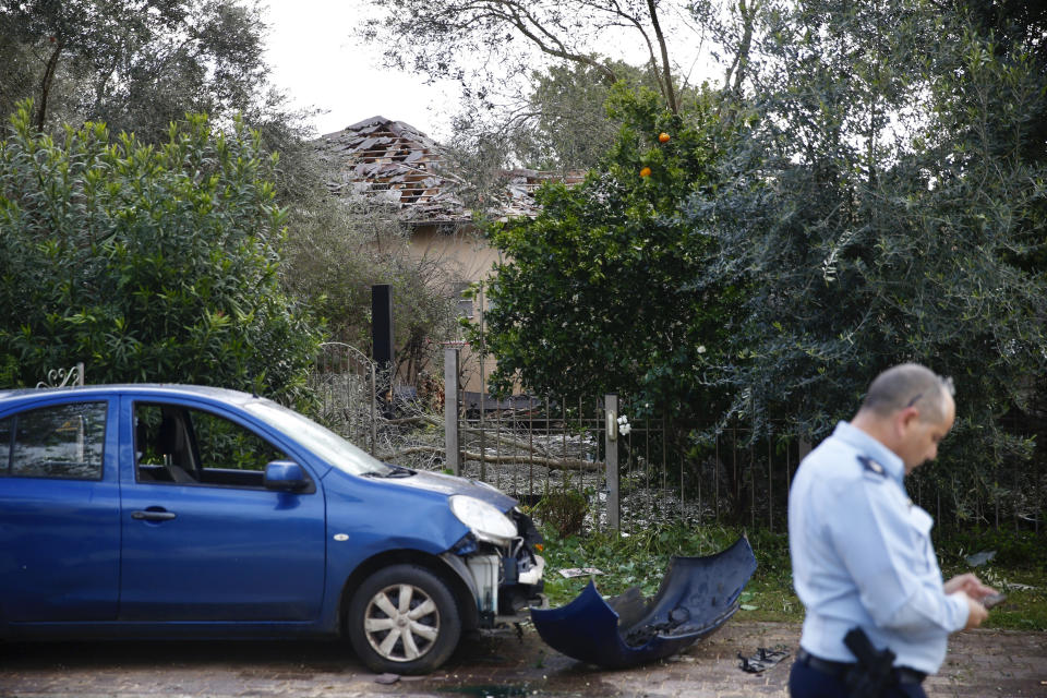 Damage to a house hit by a rocket is seen in Mishmeret, central Israel, Monday, March 25, 2019. An early morning rocket from the Gaza Strip struck a house in central Israel on Monday, wounding several people, an Israeli rescue service said, in an eruption of violence that could set off another round of violence shortly before the Israeli election. (AP Photo/Ariel Schalit)