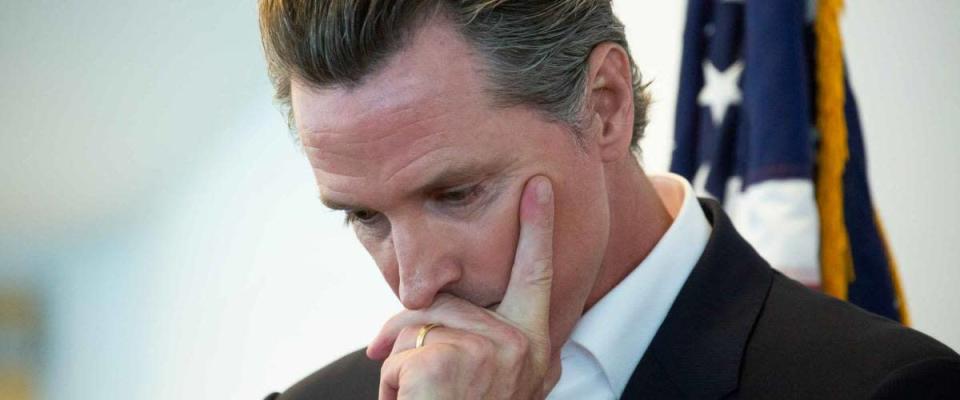 Sacramento, California / USA - May 31,  2020: California State Governor Gavin Newsom holds his head in though before a meeting.