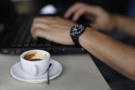 File Photo: A patron uses his laptop while having an espresso at the Silver lake location of Intelligentsia Coffee and Tea in the Silver Lake area of Los Angeles October 19, 2010. REUTERS/Mario Anzuoni