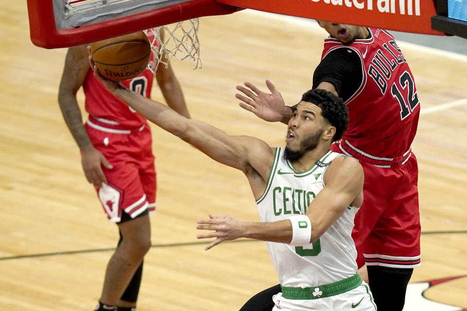 Boston Celtics' Jayson Tatum scores on a reverse layup during the first half of an NBA basketball game against the Chicago Bulls, Monday, Jan. 25, 2021, in Chicago. (AP Photo/Charles Rex Arbogast)