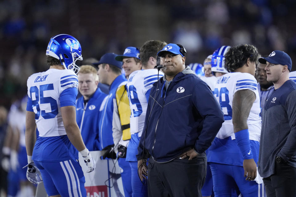 BYU coach Kalani Sitake, middle, watches during the first half of the team's NCAA college football game against Stanford in Stanford, Calif., Saturday, Nov. 26, 2022. (AP Photo/Godofredo A. Vásquez)