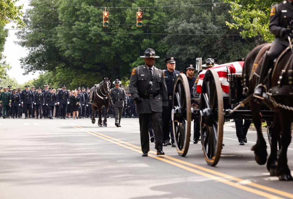 A horse-drawn carriage carries the body of officer Joshua Eyer to First Baptist Church on Friday, May3, 2024. Officer Eyer was killed while serving a warrant in east Charlotte on Monday, April 29, 2024