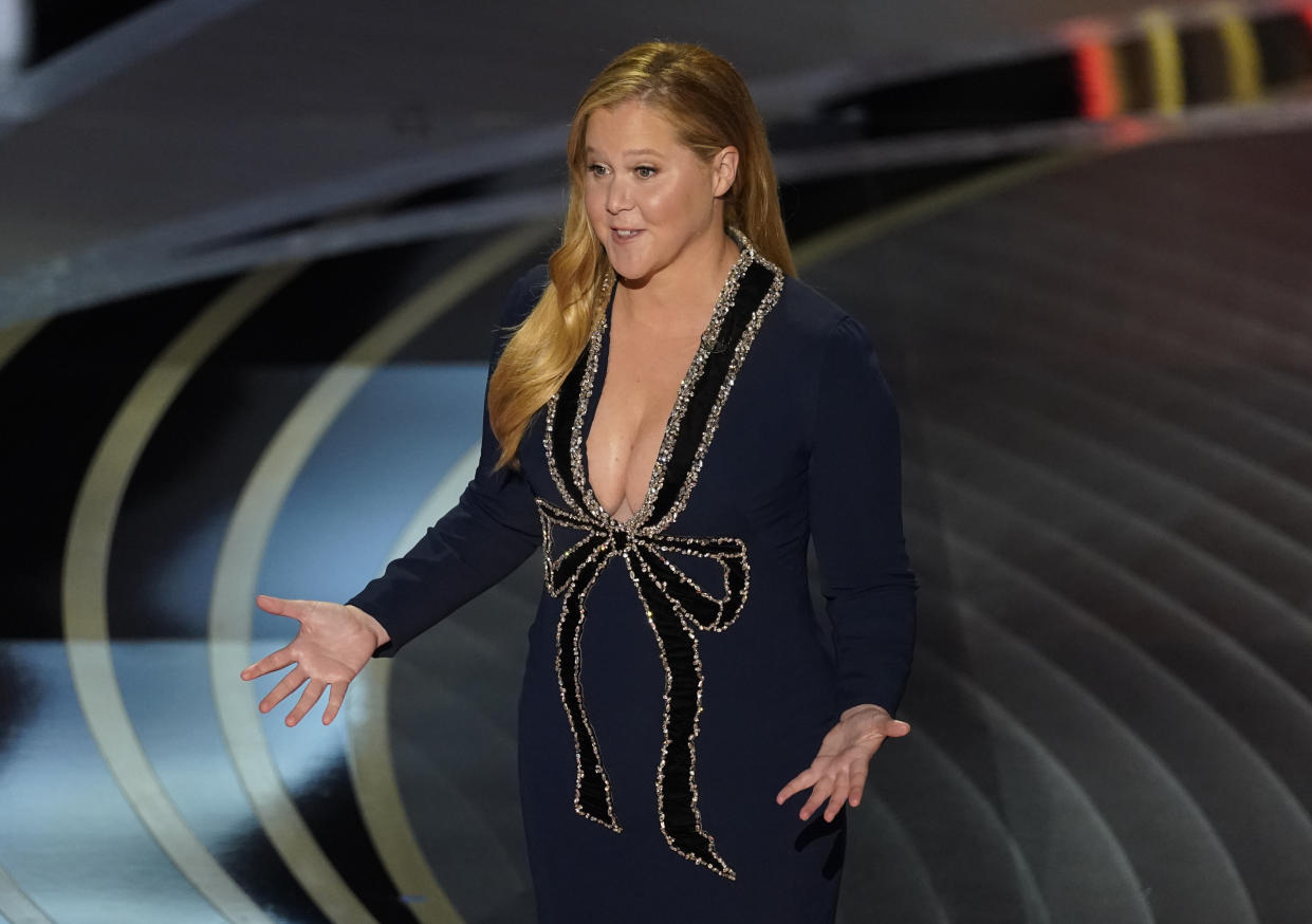 Host Amy Schumer appears onstage at the Oscars on Sunday, March 27, 2022, at the Dolby Theatre in Los Angeles. (AP Photo/Chris Pizzello)