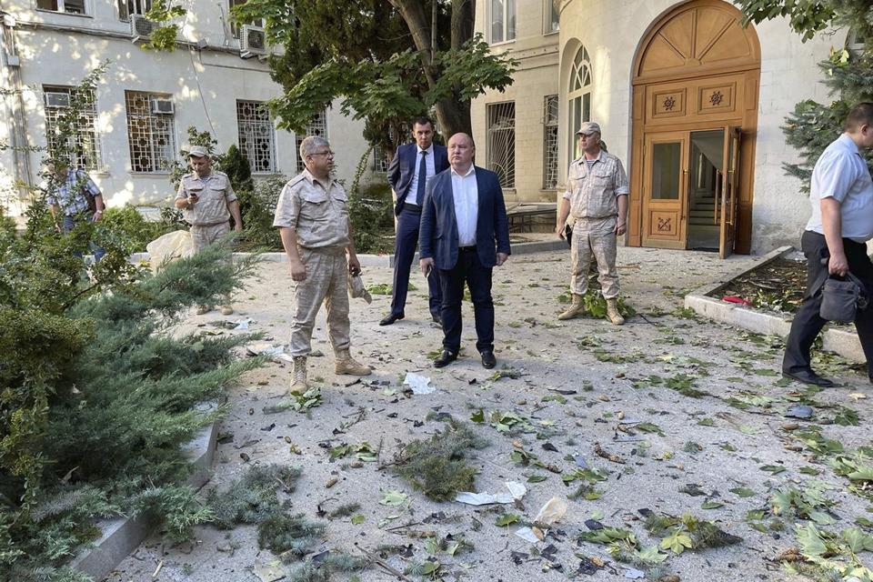 FILE - In this handout photo released by Sevastopol mayor Mikhail Razvozhaev telegram channel on Sunday, July 31, 2022, Governor of Sevastopol Mikhail Vladimirovich Razvozhayev, center, stands at the scene of explosion at the headquarters of Russia's Black Sea Fleet in Sevastopol, Crimea. A spate of drone attacks that Russian authorities blamed on Ukraine has targeted areas in southern and western Russia, reflecting the Ukrainian military's growing reach as the war dragged into a second year. (Sevastopol mayor Mikhail Razvozhaev telegram channel via AP, File)