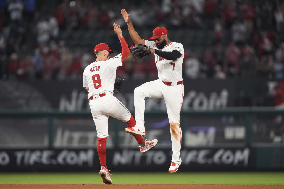 Los Angeles Angels shortstop Zach Neto, left, and right fielder Jo Adell celebrate the team's win in a baseball game against the Detroit Tigers, Friday, June 28, 2024, in Anaheim, Calif. (AP Photo/Ryan Sun)