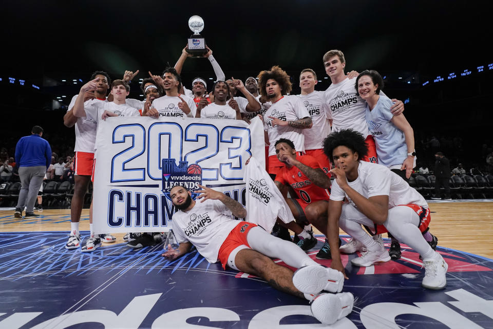 Auburn players pose for a photo after winning an NCAA college basketball game against St. Bonaventure, the final of the Legends Classic tournament, in New York, Friday, Nov. 17, 2023. (AP Photo/Peter K. Afriyie)