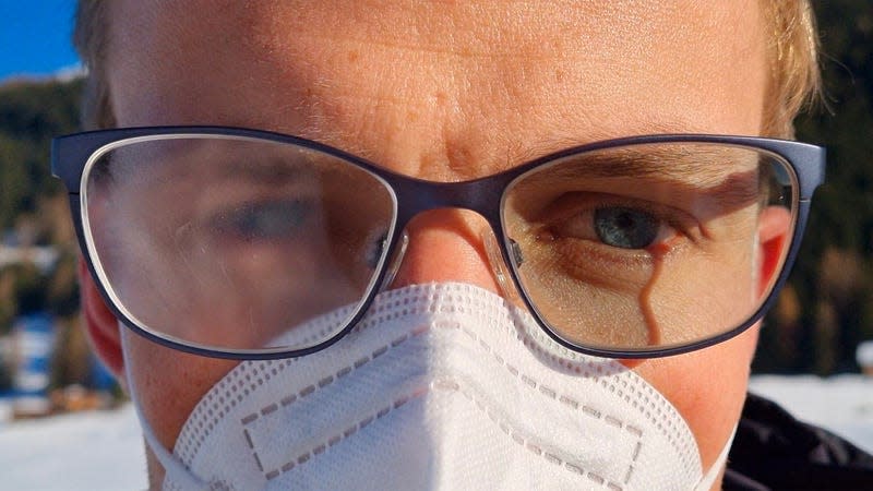 A person wearing glasses outside in the snow with one lens fogged up while the other is free of condensation.