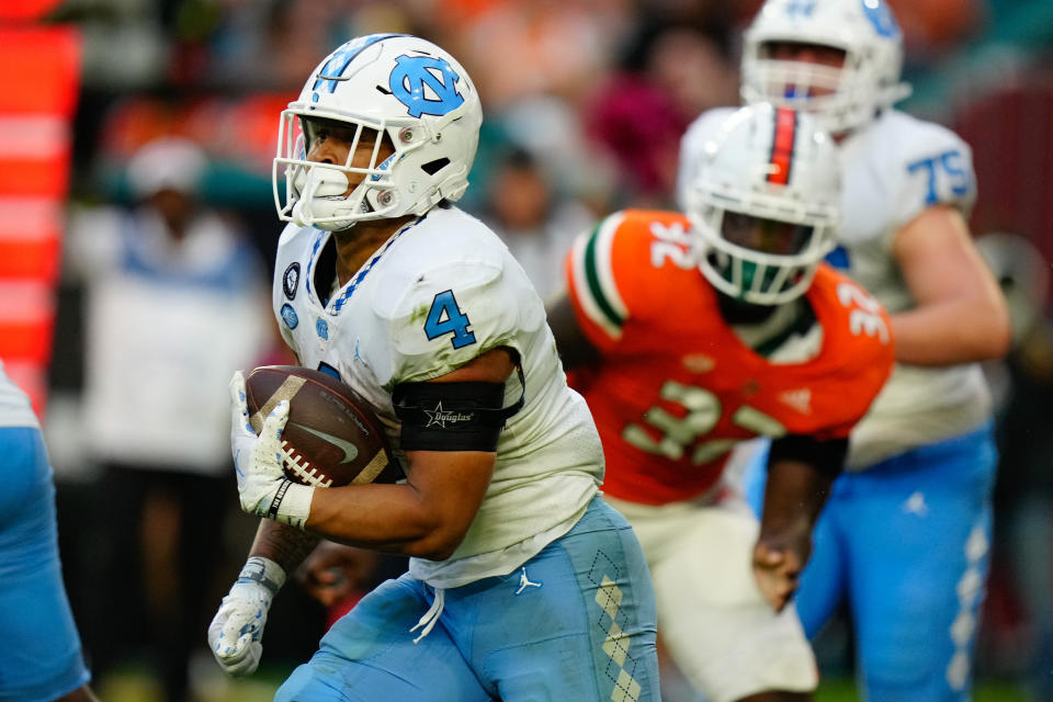 Oct 8, 2022; Miami Gardens, Florida, USA; North Carolina Tar Heels running back Caleb Hood (4) runs the ball against the Miami Hurricanes during the second half at Hard Rock Stadium. Mandatory Credit: Rich Storry-USA TODAY Sports