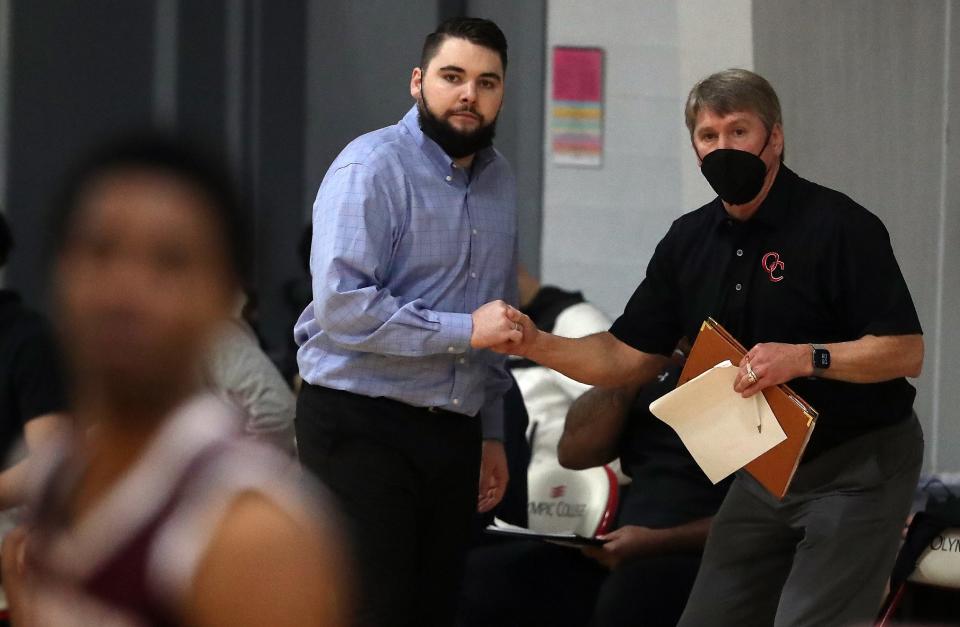 OC Rangers head coach Ryley Callaghan shakes hands with his father and assistant coach John Callaghan as the second half starts during their game against the Whatcom Orcas in Bremerton on Wednesday, Feb. 9, 2022.