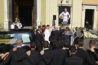 Friends and family stand close as they pray before the funeral ceremony for late Marussia Formula One driver Jules Bianchi at the Sainte Reparate Cathedral in Nice, July 21, 2015. Bianchi, 25, died in hospital in Nice on Friday, nine months after his crash at Suzuka in Japan and without regaining consciousness. REUTERS/Jean-Pierre Amet