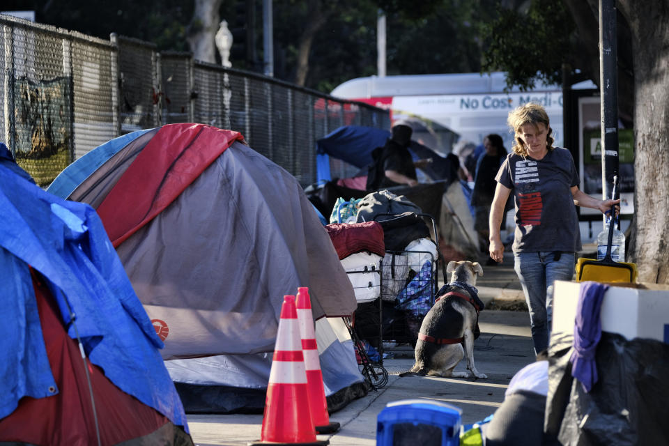 Homeless people move belongings from a street near Los Angeles City Hall as crews prepared to clean the area on Monday, July 1, 2019.&nbsp; (Photo: ASSOCIATED PRESS)