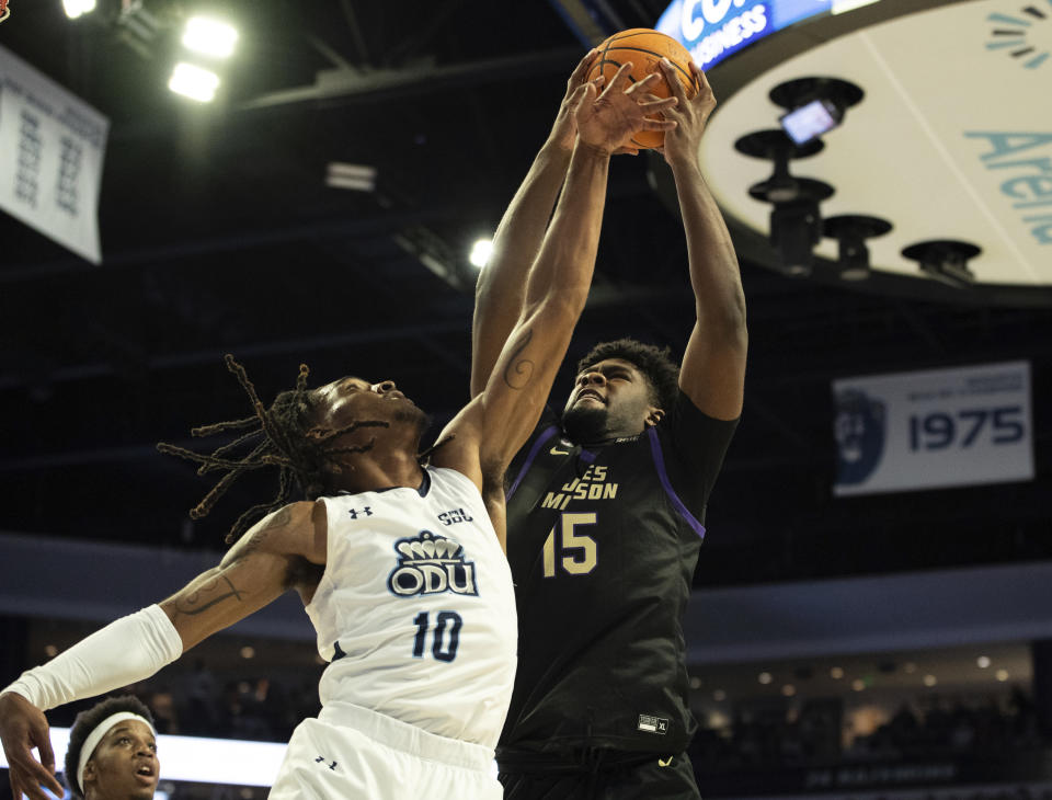 James Madison forward Jaylen Carey (15) goes up for a basket as he is defended by Old Dominion guard Tyrone Williams (10) during the first half of an NCAA college basketball game Saturday, Dec. 9, 2023, in Norfolk, Va. (AP Photo/Mike Caudill)