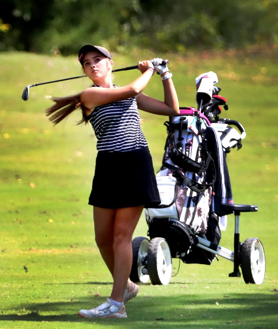 Central's Anna Powell watches the ball after hitting it on the fairway to the green on the 8th hole during the District 10-AA Golf Tournament, at Indian Hills Golf Course, on Monday, Sept. 18, 2023.