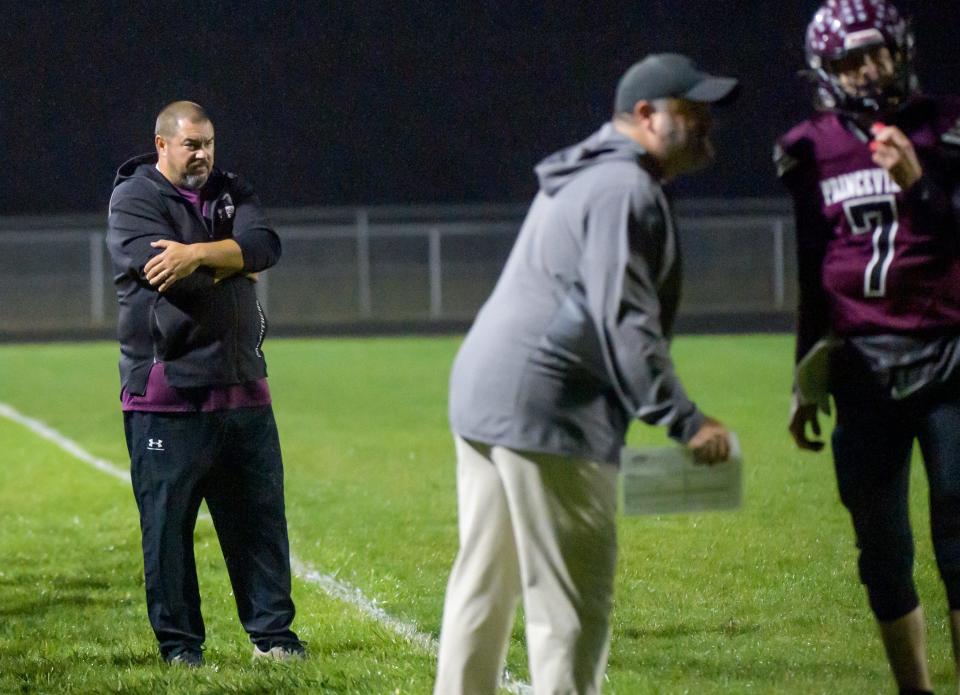 Princeville head coach Jon Carruthers stands by as his son and senior quarterback Logan (7) gets his next play in the first half of a Week 8 football game against Rushville-Industry on Friday, Oct. 13, 2023 at Princeville High School.