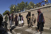 Taliban fighters stand guard in front of an education center that was attacked by a suicide bomber, in Kabul, Afghanistan, Friday, Sept. 30, 2022. A Taliban spokesman says a suicide bomber has killed several people and wounded others at an education center in a Shiite area of the Afghan capital. The bomber hit while hundreds of teenage students inside were taking practice entrance exams for university, a witness says. (AP Photo/Ebrahim Noroozi)
