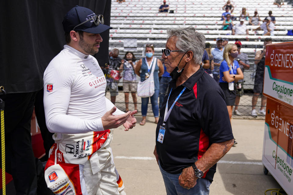 Marco Andretti, left, talks with his grandfather and Indianapolis 500 champion Mario Andretti during practice for the Indianapolis 500 auto race at Indianapolis Motor Speedway in Indianapolis, Friday, May 21, 2021. (AP Photo/Michael Conroy)