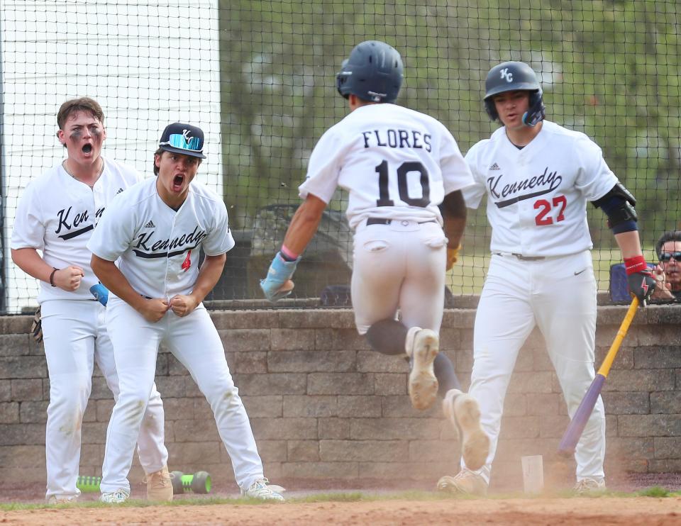 Kennedy CatholicÕs Eddie Flores (10) is greeted by happy teammates after scoring from third on a sacrifice fly against Iona during baseball action at Kennedy Catholic in Somers May 1, 2024. Kennedy won the game 4-3.