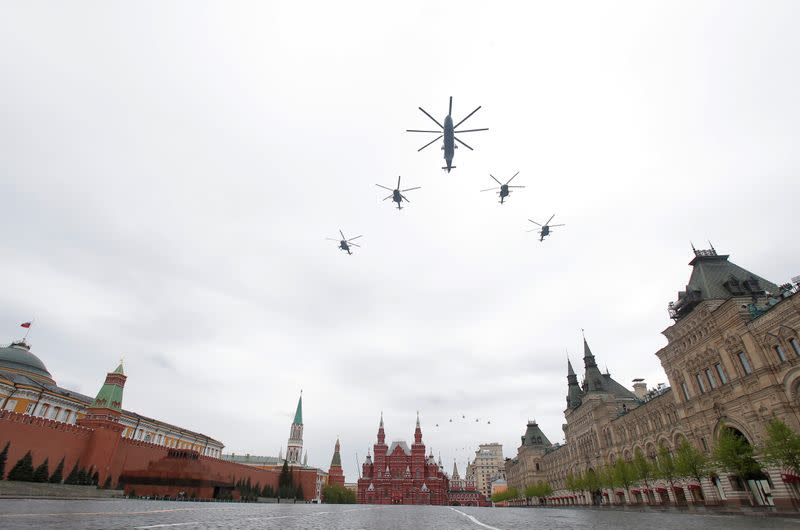 Helicopters fly in formation during an air parade on Victory Day in central Moscow