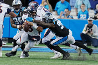 Denver Broncos quarterback Russell Wilson is sacked by Carolina Panthers defensive end Marquis Haynes Sr. during the second half of an NFL football game between the Carolina Panthers and the Denver Broncos on Sunday, Nov. 27, 2022, in Charlotte, N.C. (AP Photo/Rusty Jones)