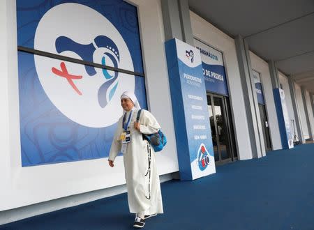 A nun walks past posters on the wall at Media Center, ahead of Pope Francis' visit for World Youth Day in Panama City, Panama January 22, 2019. REUTERS/Henry Romero