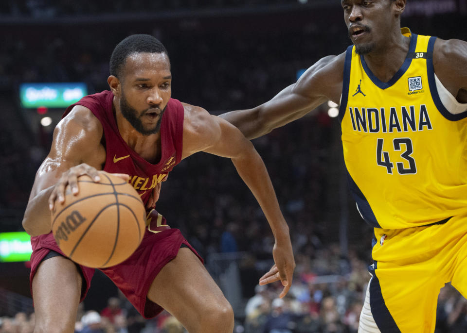 Cleveland Cavaliers' Evan Mobley, left, is guarded by Indiana Pacers' Pascal Siakam (43) during the first half of an NBA basketball game in Cleveland, Friday, April 12, 2024. (AP Photo/Phil Long)