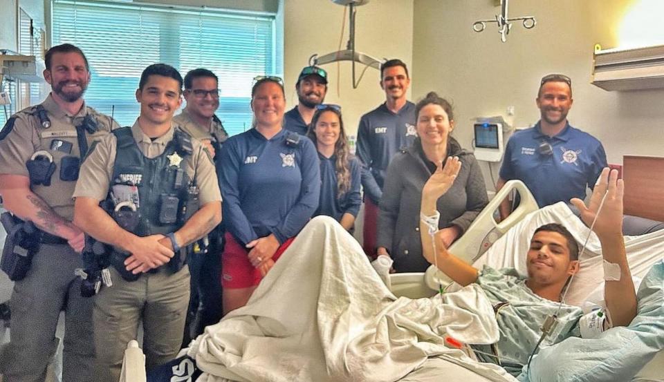 PHOTO: First responders reunited with Felipe Desouza after they rescued him from a rip current, March 30, 2024, off the coast of New Smyrna Beach, Fla. (Volusia County Beaches )