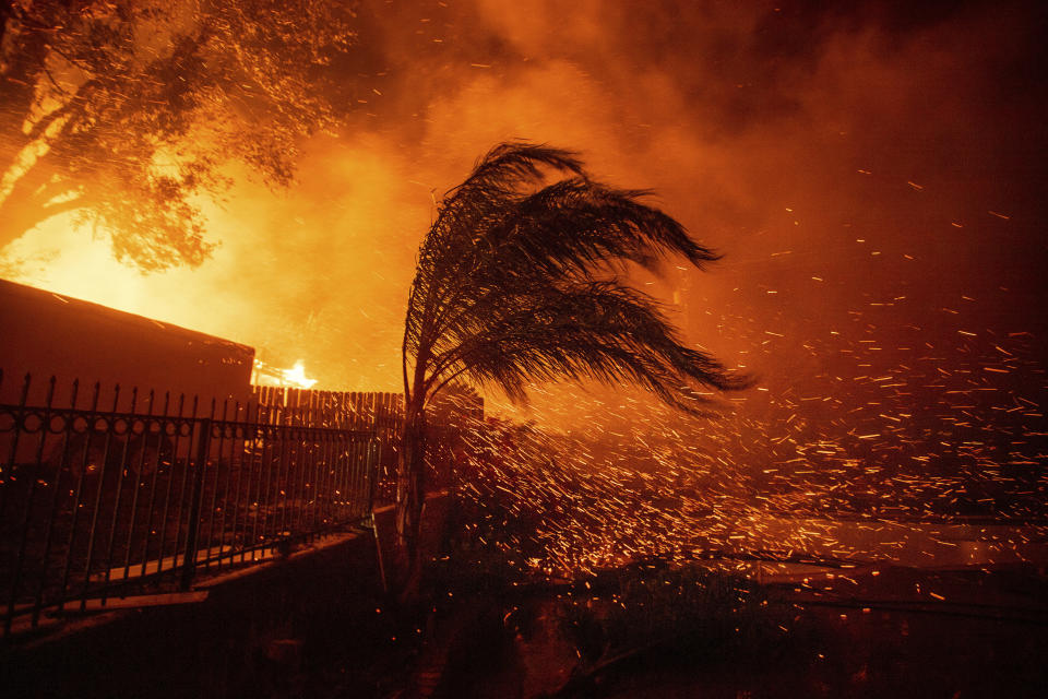 Strong, dry winds send embers flying as the Hillside Fire burns in San Bernardino, Calif., on Thursday, Oct. 31, 2019. The blaze, which ignited during red flag fire danger warnings, destroyed multiple residences. (AP Photo/Noah Berger)