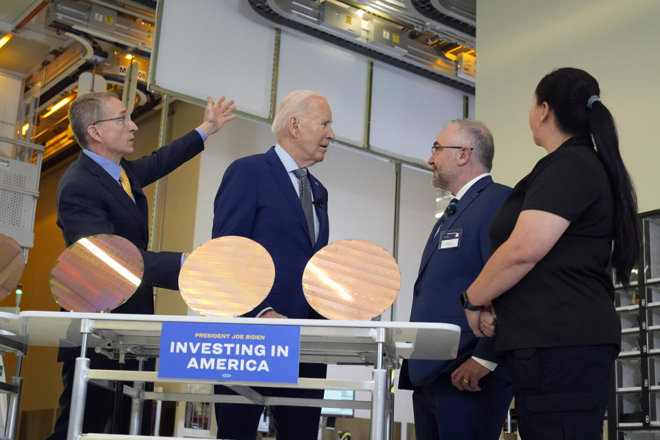 President Joe Biden listens to Intel CEO Pat Gelsinger, left, as Intel factory manager Hugh Green and Intel manufacturing technician Michelle Blackwell listen, during a tour of the Intel Ocotillo Campus, in Chandler, Ariz., Wednesday March 20, 2024. (AP Photo/Jacquelyn Martin)
