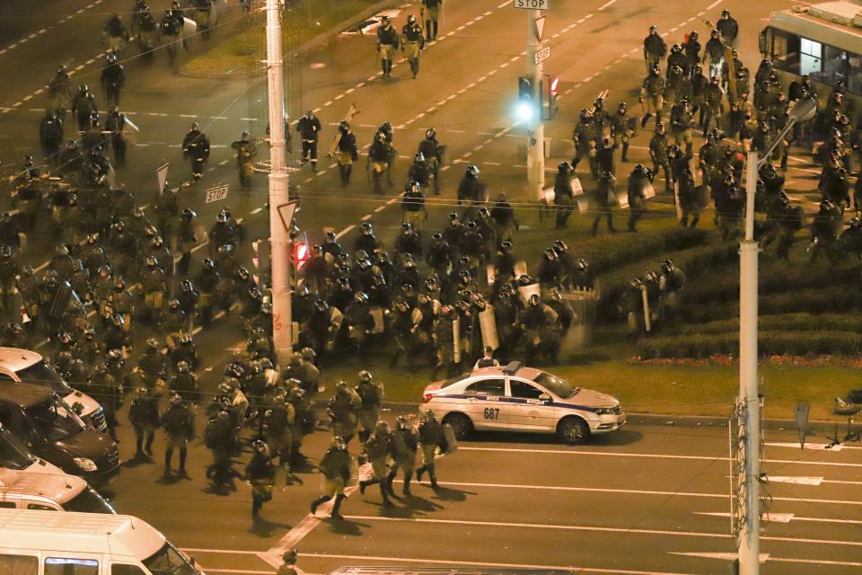 Police move to block demonstrators during a mass rally following the presidential election in Minsk, Belarus, late Tuesday, Aug. 11, 2020. Belarus officials say police detained over 1,000 people during the latest protests against the results of the country's presidential election. An Interior Ministry spokeswoman says rallies took place in 25 Belarusian cities on Tuesday, the third night of protests contesting the election results. (AP Photo)