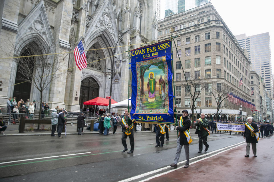 FILE - People march past St. Patrick's Cathedral in the St. Patrick's Day parade on Thursday, March 17, 2022, in New York City. The day honoring the patron saint of Ireland is a global celebration of Irish heritage. And nowhere is that more so than in the United States, where parades take place in cities around the country and all kinds of foods and drinks are given an emerald hue. (AP Photo/Ted Shaffrey, File)