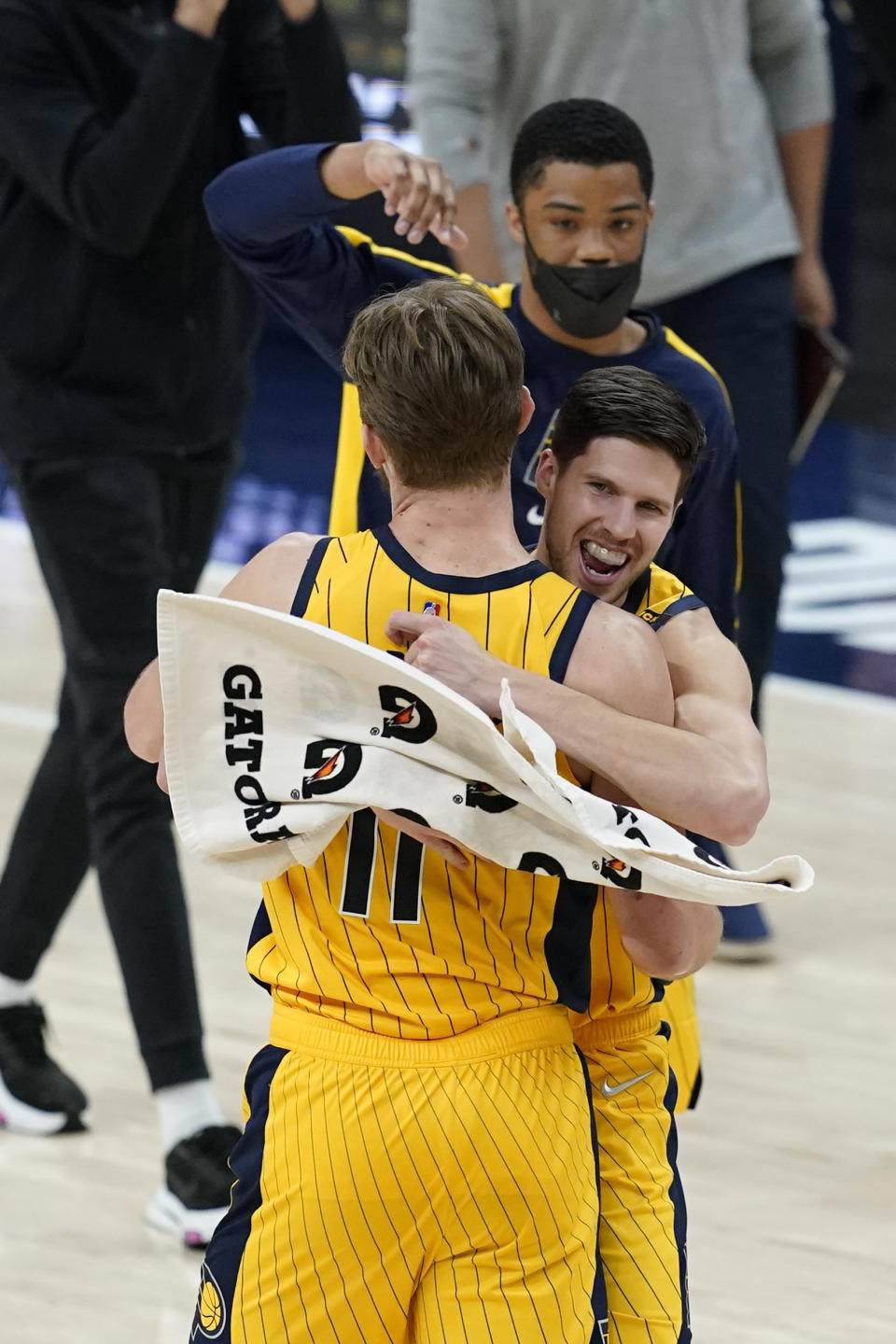 Indiana Pacers' Domantas Sabonis (11) and Doug McDermott (20) celebrate following an NBA basketball game against the Philadelphia 76ers, Tuesday, May 11, 2021, in Indianapolis. Indiana won 103-94. (AP Photo/Darron Cummings)