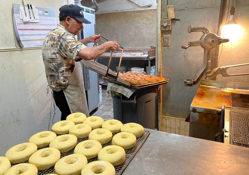 Luis Villagomez fries donuts at El Gallito Bakery in Planada, California on July 6, 2023. His business lost thousands of dollars worth of equipment and baking ingredients during January’s flood.