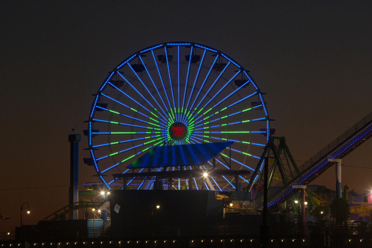 Pacific Park's solar-powered Ferris wheel lights show a green 