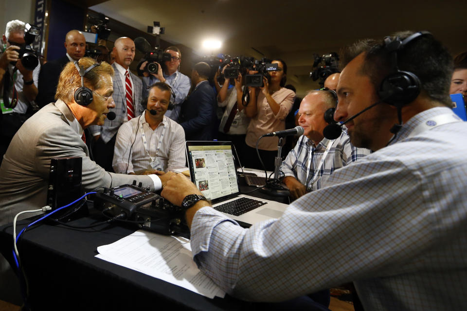 Alabama head coach Nick Saban, left, visits Radio Row during the NCAA college football Southeastern Conference Media Days, Wednesday, July 17, 2019, in Hoover, Ala. (AP Photo/Butch Dill)