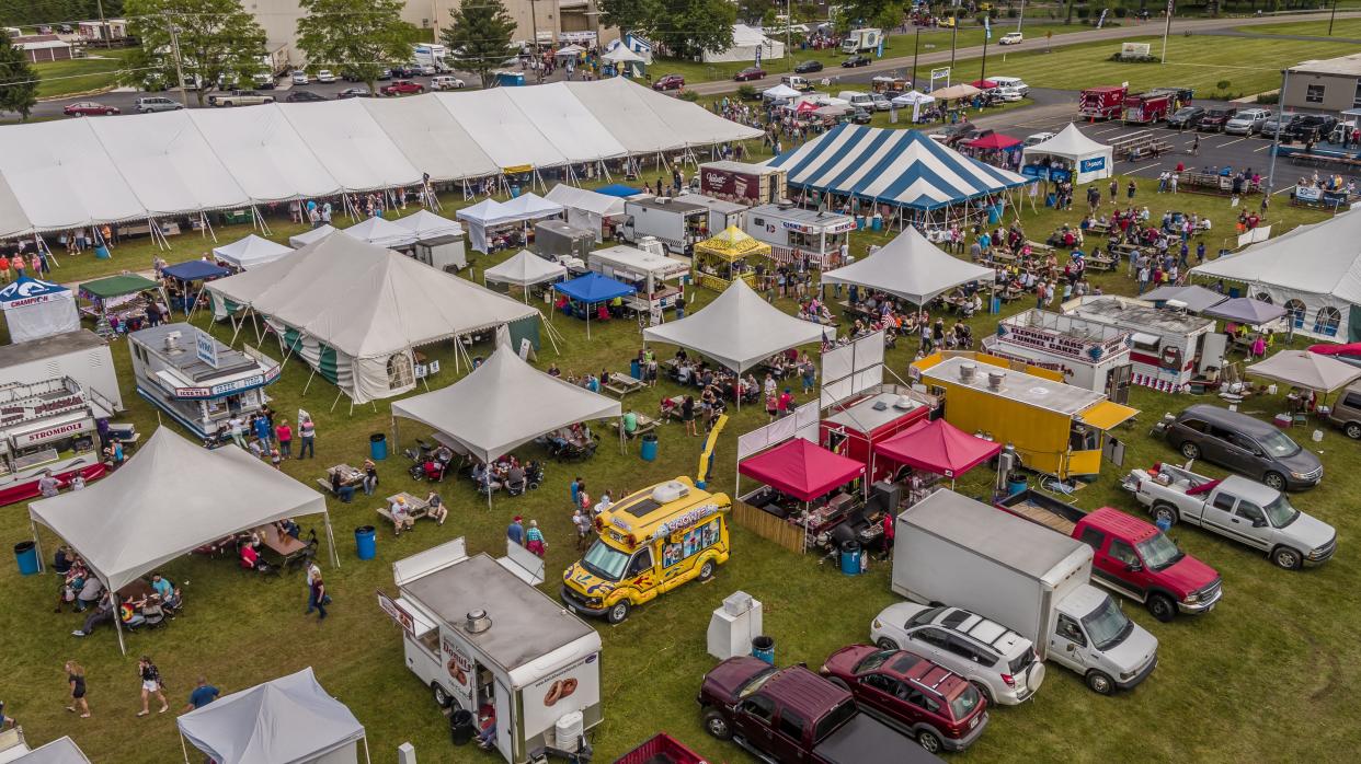 People gather for the Utica Sertoma Ice Cream Festival at Velvet Ice Cream.