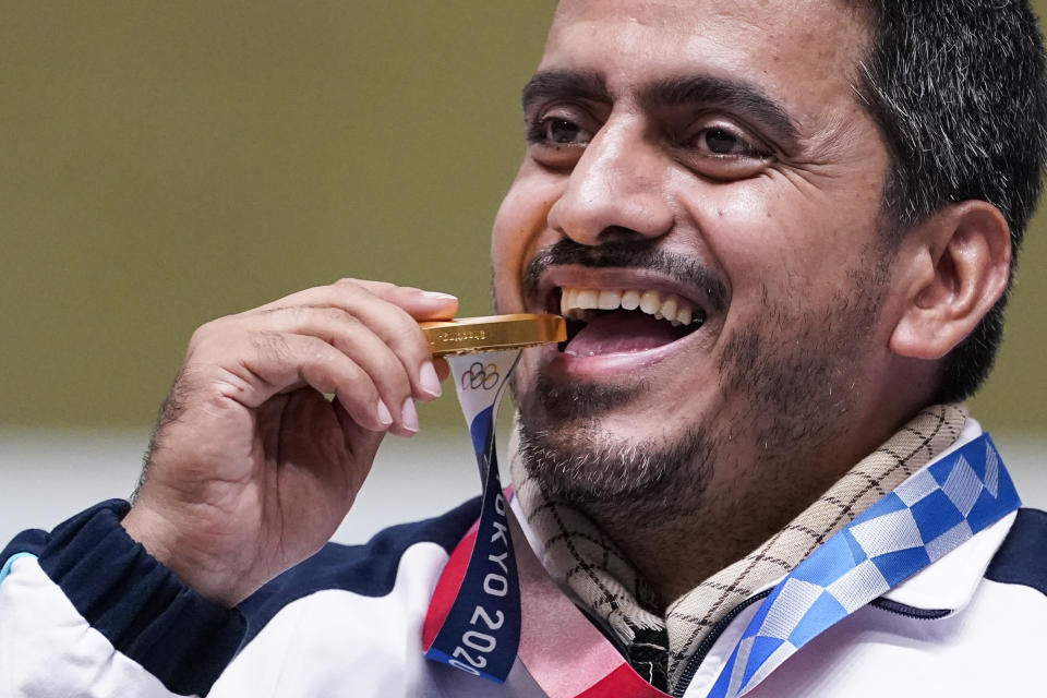 Javad Foroughi, of Iran, celebrates after winning the gold medal in the men's 10-meter air pistol at the Asaka Shooting Range in the 2020 Summer Olympics, Saturday, July 24, 2021, in Tokyo, Japan. (AP Photo/Alex Brandon)