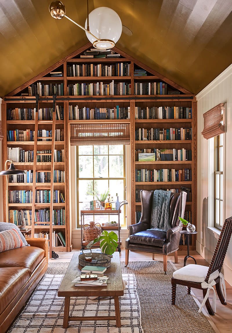 <p>Long afternoons will be spent curled up with a good book in this library complete with floor-to-ceiling bookshelves. </p>