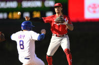 Cincinnati Reds second baseman Jonathan India, right, hrows to first base after forcing out Chicago Cubs' Ian Happ (8) at second base during the eighth inning of a baseball game Sunday, Oct. 2, 2022, in Chicago. (AP Photo/Paul Beaty)