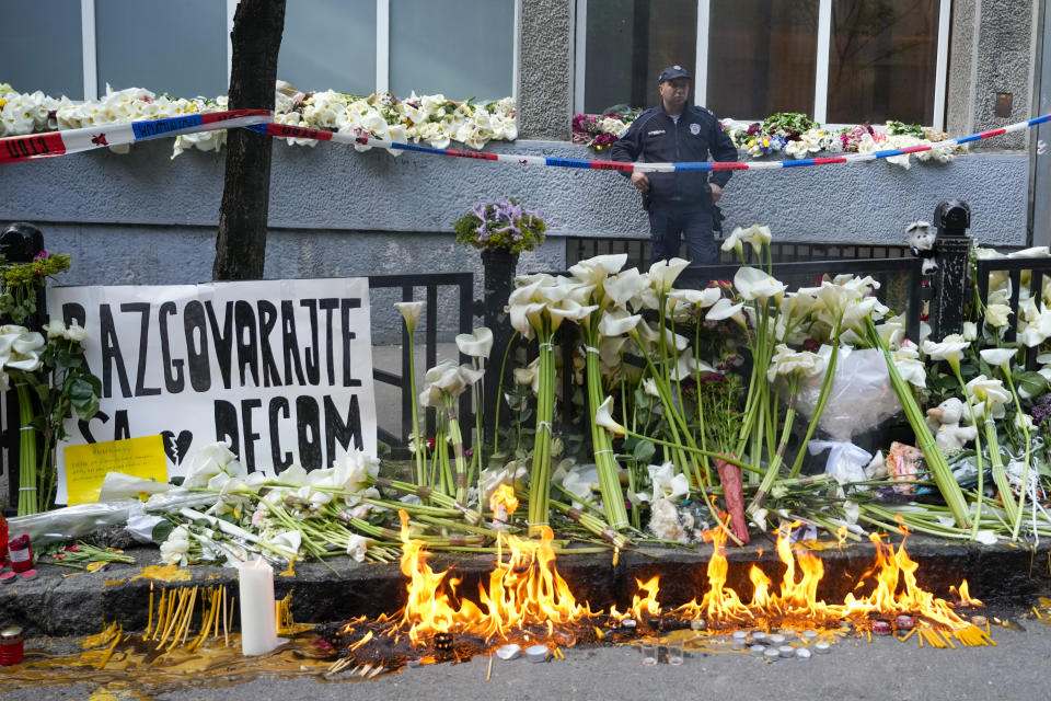 A police officer guards the Vladimir Ribnikar school, two days after a 13-year-old boy used his father's guns to kill eight fellow students and a guard, in Belgrade, Serbia, Friday, May 5, 2023. The bloodshed sent shockwaves through a Balkan nation scarred by wars, but unused to mass murders. (AP Photo/Darko Vojinovic)