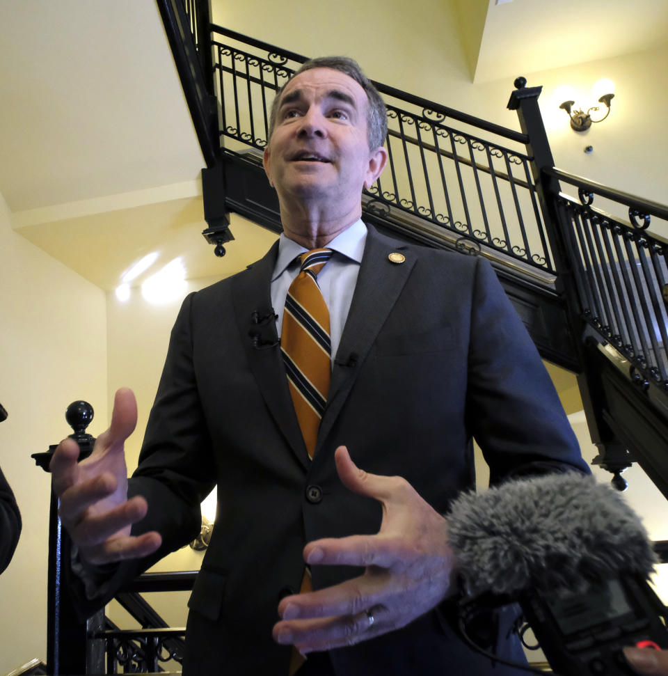 Gov. Ralph Northam talks with members of the media after a press conference at the State Capitol, Monday, Jan. 6, 2020, and previewed his voting legislative proposals, including removing Lee-Jackson Day as a state holiday and replacing it with election day. (Bob Brown)/Richmond Times-Dispatch via AP)