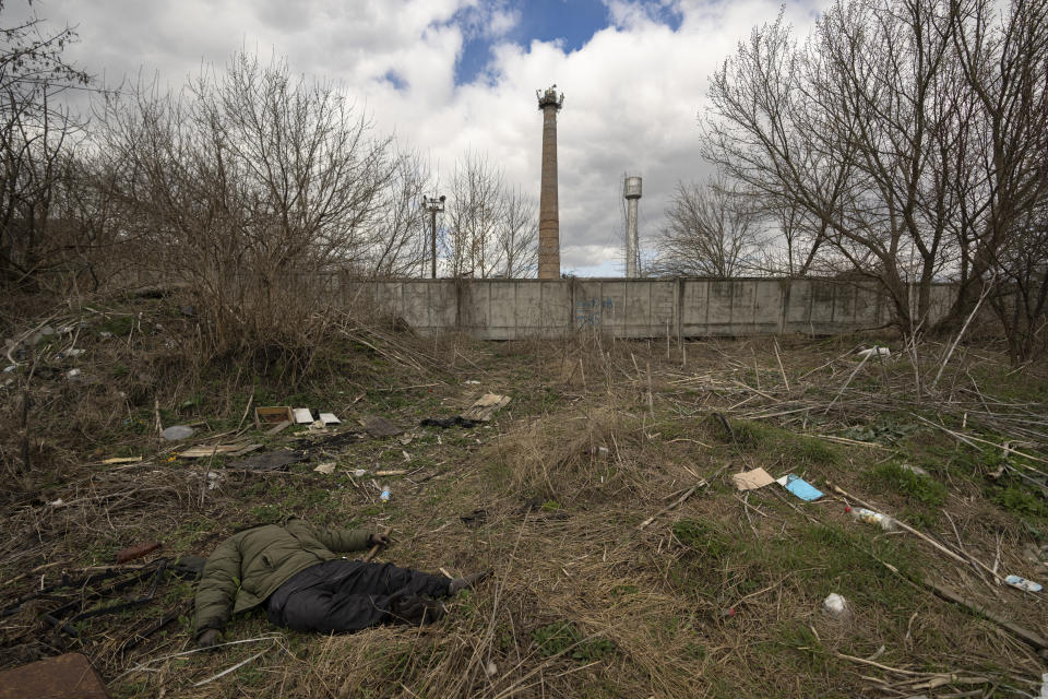 The lifeless body of a man who, according to locals was shot by a sniper, lies on the side of a dirt path in Bucha, Ukraine, Monday, April 4, 2022. Russia faced a fresh wave of condemnation on Monday after evidence emerged of what appeared to be deliberate killings of civilians in Ukraine. Some Western leaders called for further sanctions in response, even as Moscow continued to press its offensive in the country's east. (AP Photo/Vadim Ghirda)