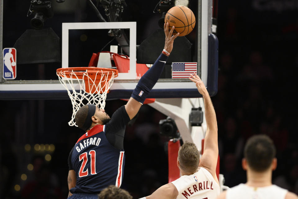 Washington Wizards center Daniel Gafford (21) blocks a shot by Cleveland Cavaliers guard Sam Merrill (5) during the first half of an NBA basketball game Wednesday, Feb 7, 2024, in Washington. (AP Photo/Nick Wass)