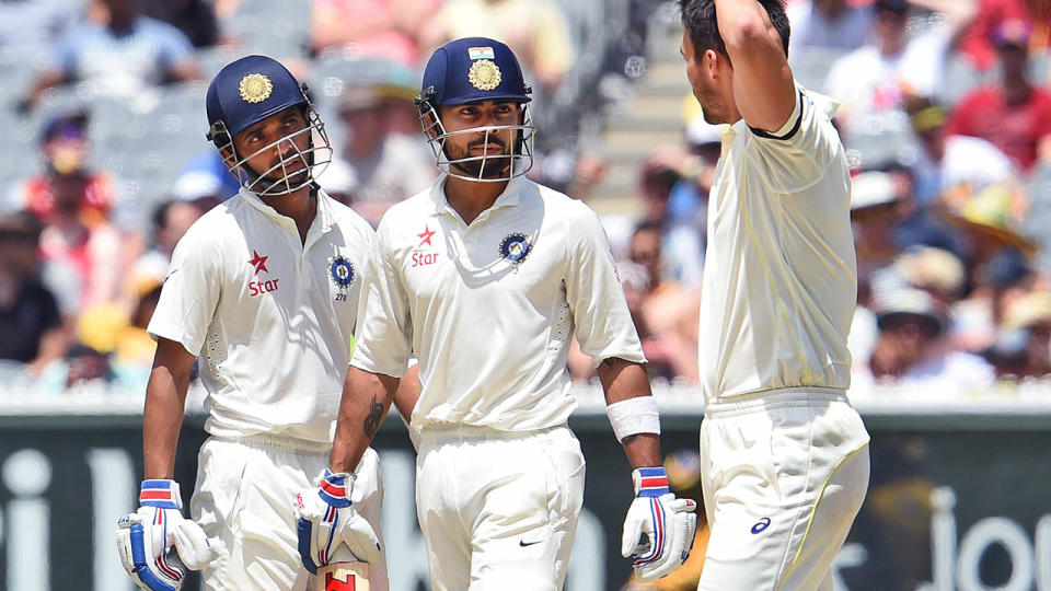 Virat Kohli (C) and tMitchell Johnson (R) in 2014. (WILLIAM WEST/AFP/Getty Images)