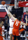 Ohio State forward Justice Sueing, left, goes up to shoot against Illinois forward Giorgi Bezhanishvili during the first half of an NCAA college basketball game in Columbus, Ohio, Saturday, March 6, 2021. (AP Photo/Paul Vernon)