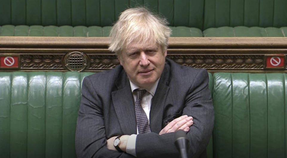In this screengrab provided by the House of Commons, Britain's Prime Minister Boris Johnson looks on during the debate in the House of Commons on the EU (Future Relationship) Bill in London, Wednesday, Dec. 30, 2020. The European Union’s top officials have formally signed the post-Brexit trade deal with the United Kingdom, as lawmakers in London get set to vote on the agreement. (House of Commons via AP)