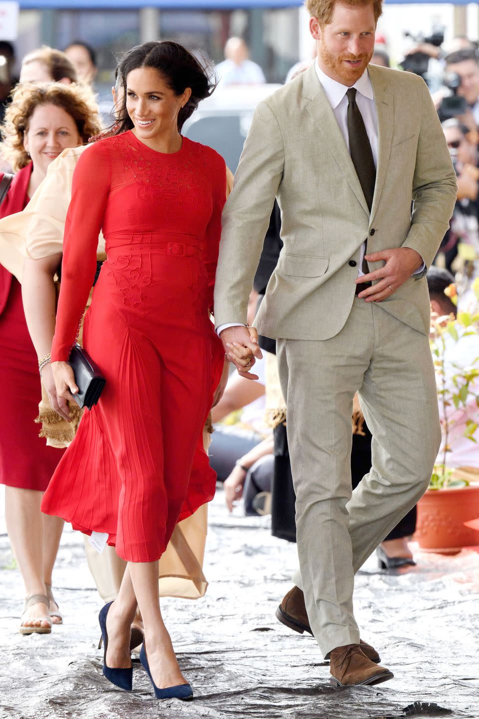 <p><strong>October 2018 </strong>She arrived with the Duke of Sussex Prince Harry at Nuku'alofa airport in a red Self-Portrait dress. </p>